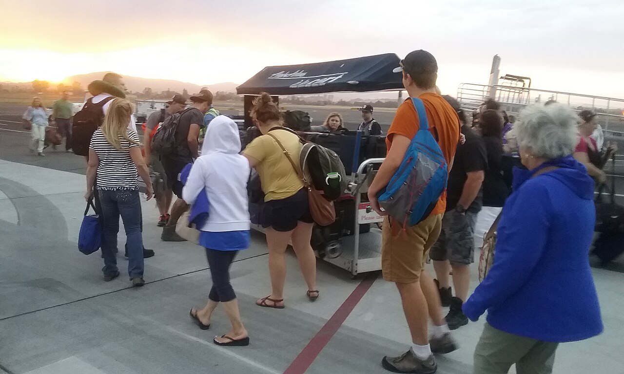 2017-09-11 STS passengers retreive luggage from a cart