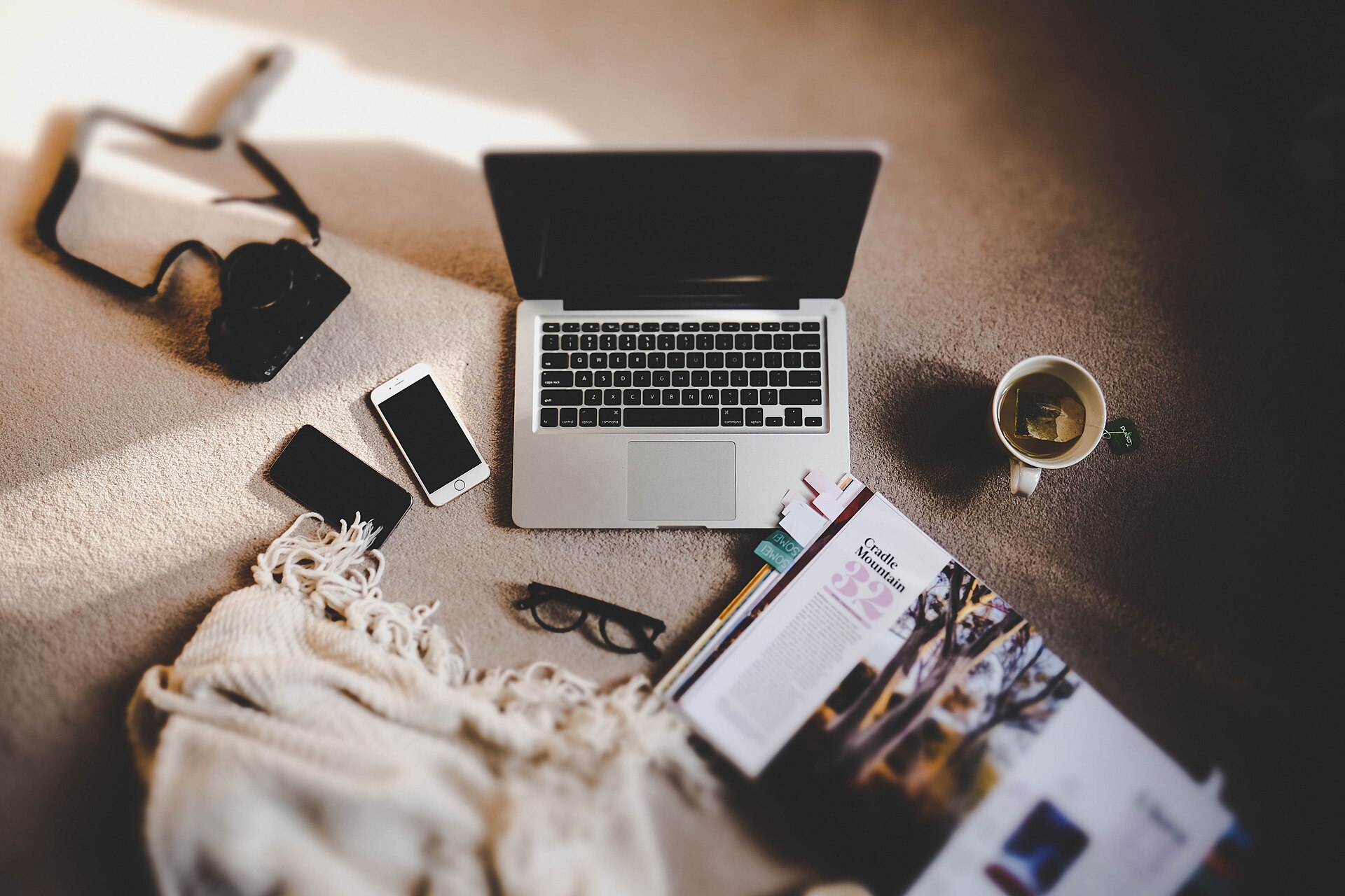 A laptop, phone and guidebook arranged for trip planning