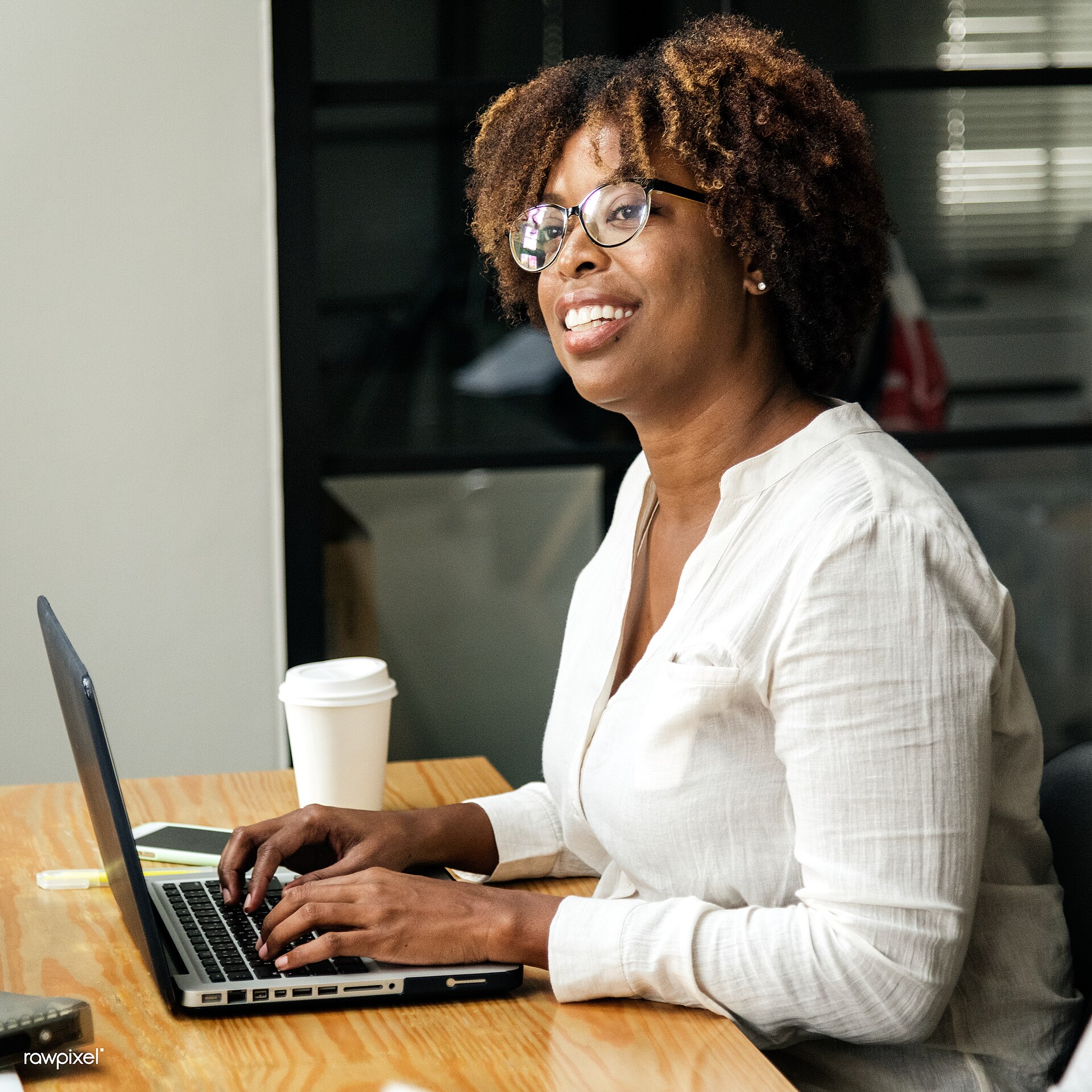 A woman using a laptop at a table