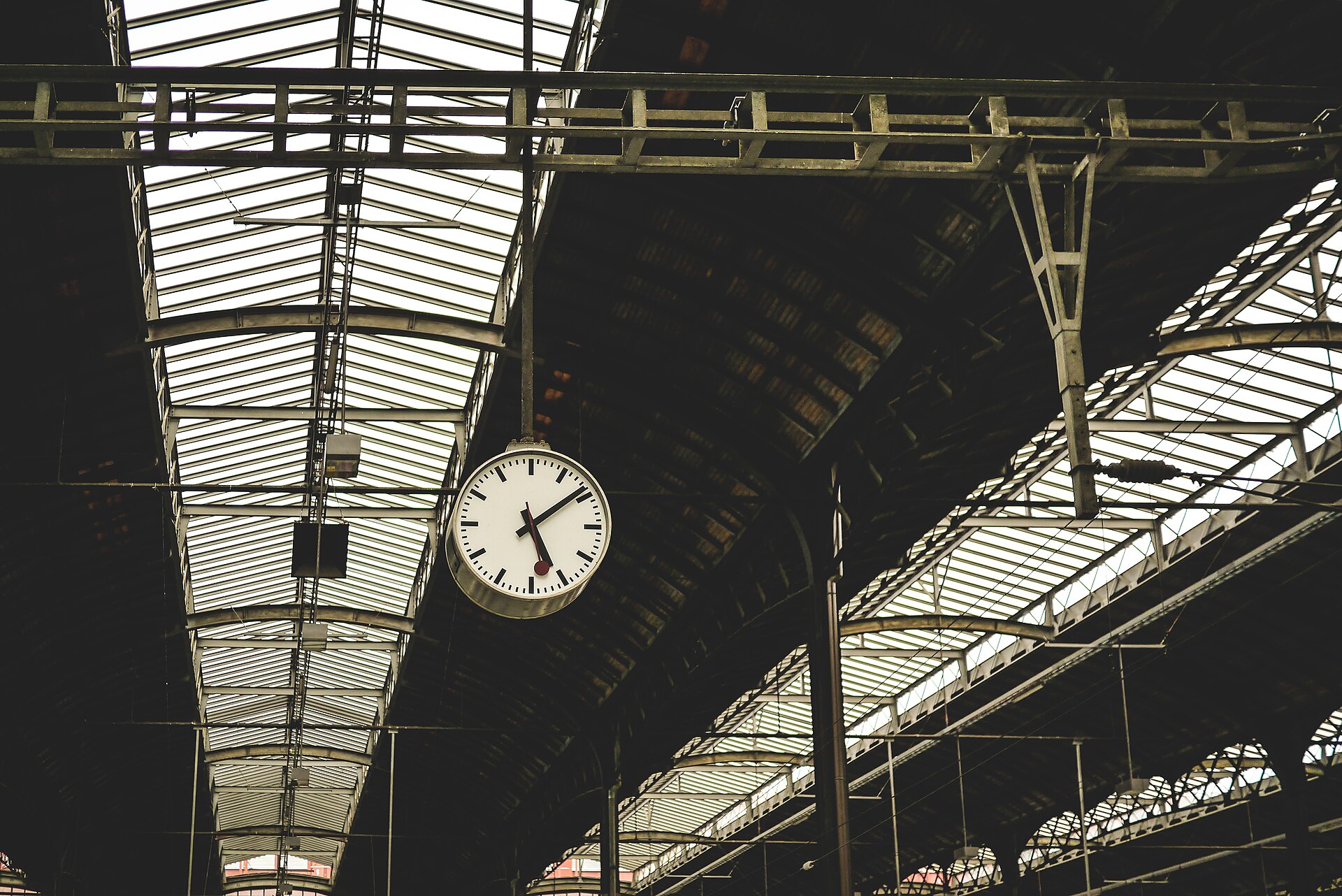 A clock hanging inside a railway station