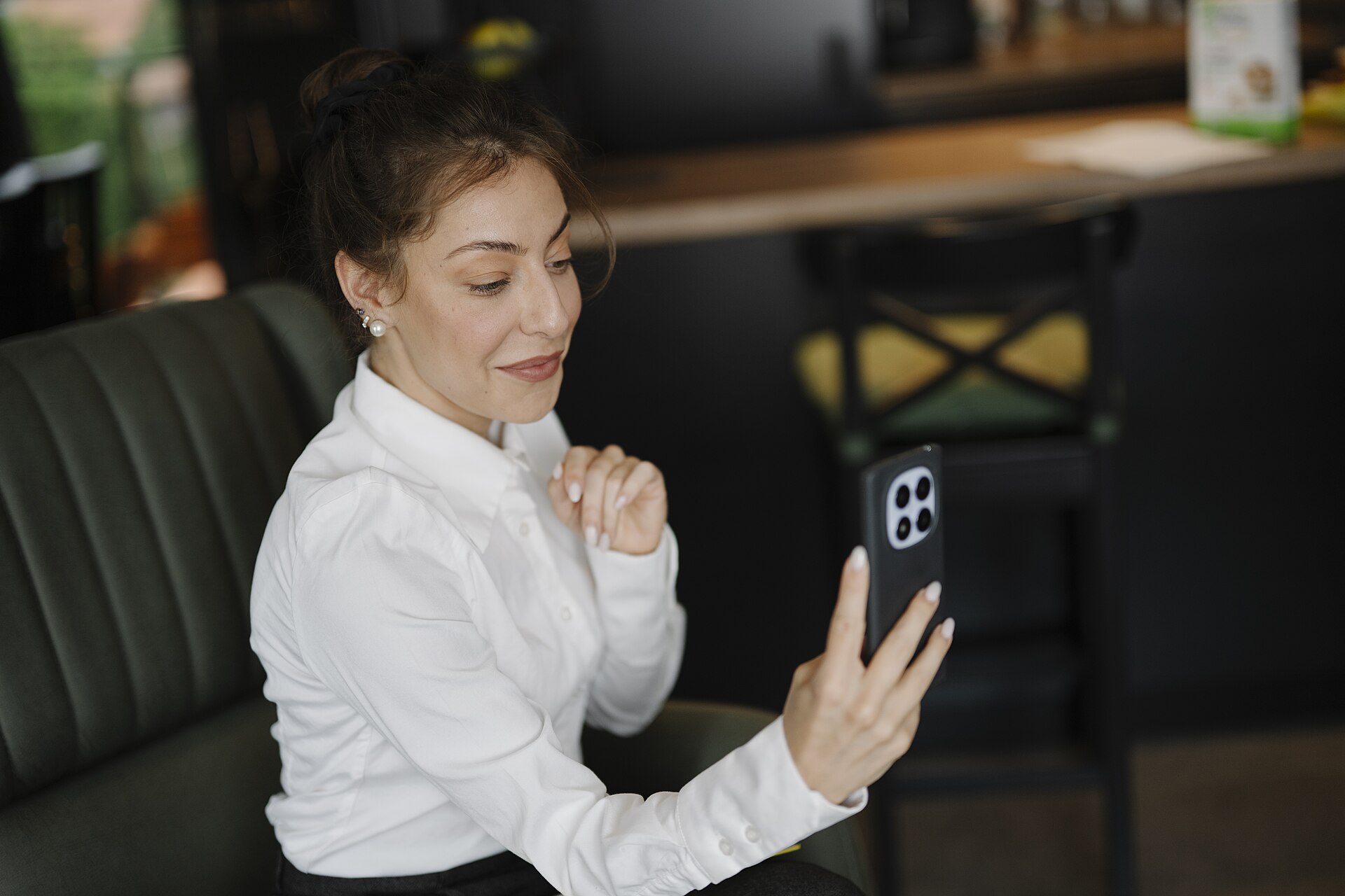 A woman making a video call from a cafe