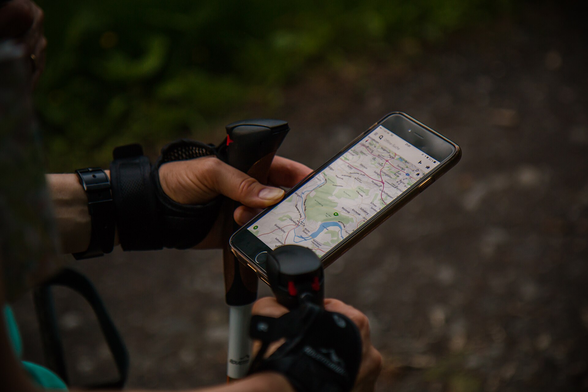 A walker consulting a smartphone map outdoors