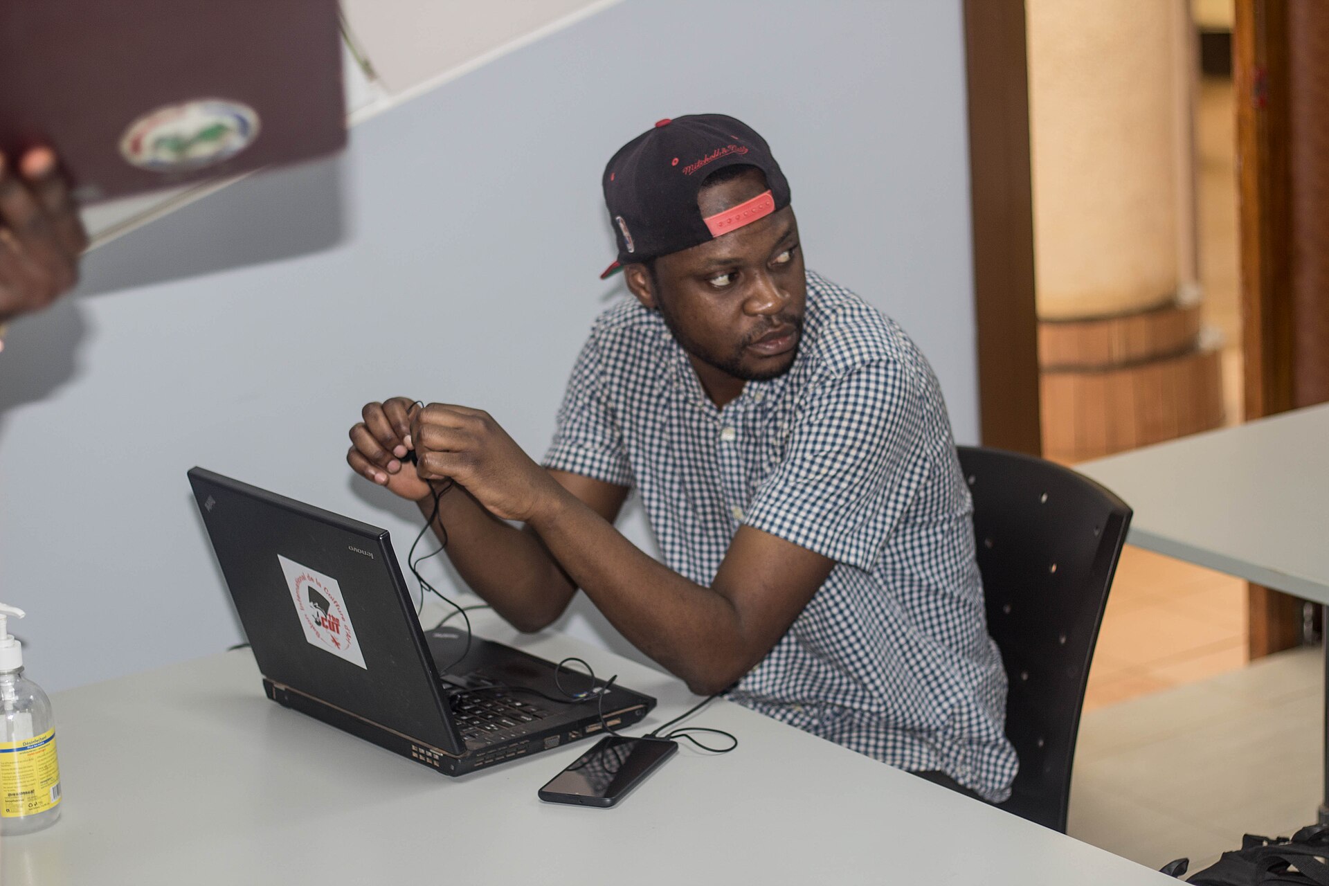 A person thinking beside an open laptop