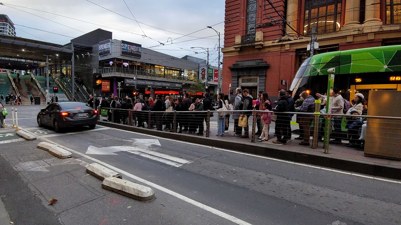 Overcrowded Bourke Street tram stop at Spencer Street as passengers attempt to exit the platform, Melbourne